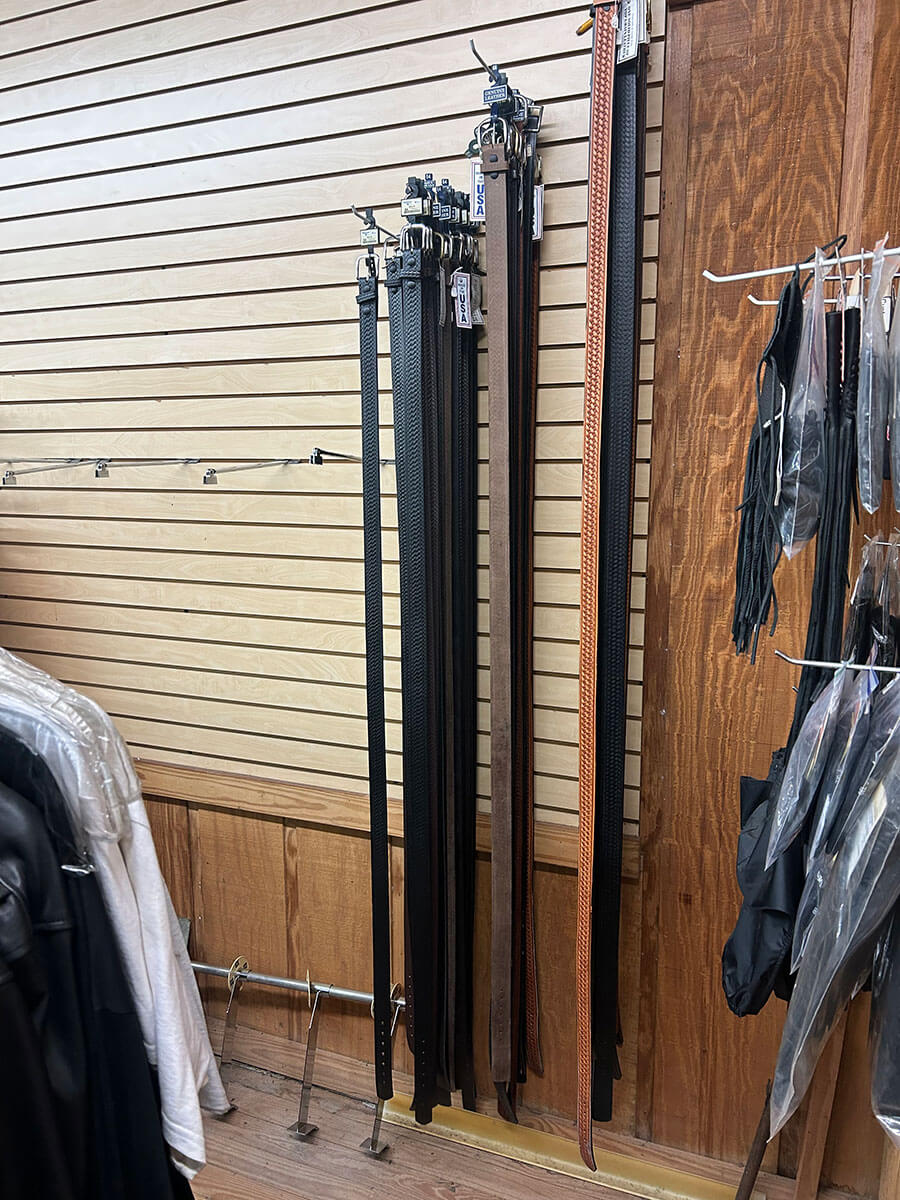 A wall of leather belts in black and brown at Kornfeld's.